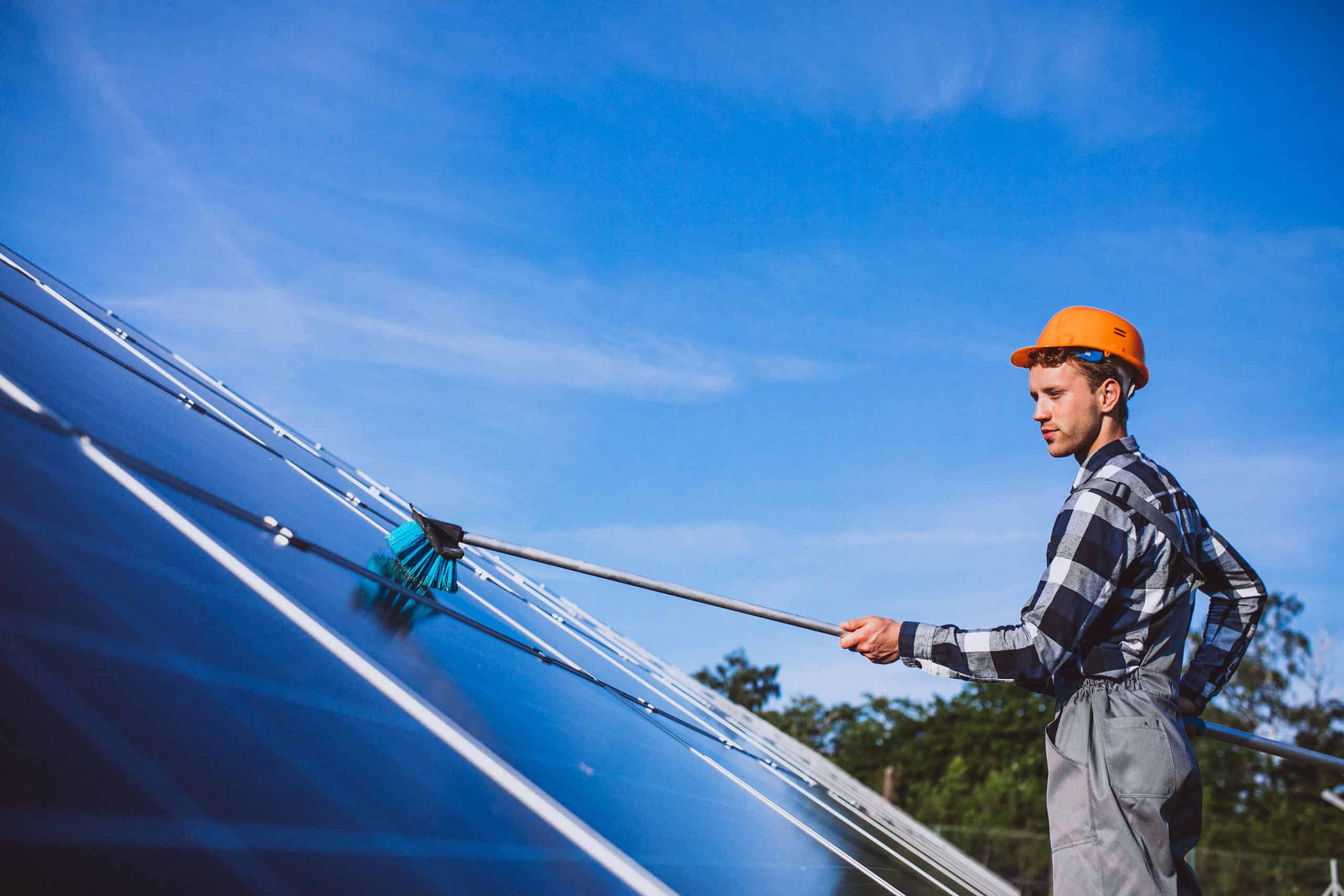 Solar technician checking and maintaining solar panel installations in the field